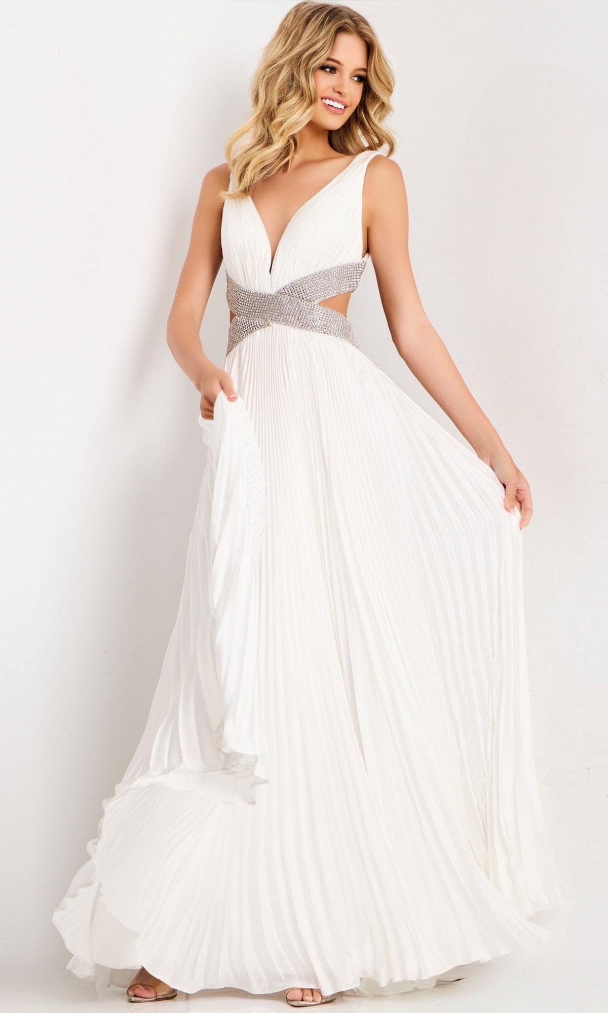 A woman models the Jovani 42811 long prom dress, featuring a sleeveless chiffon design with a deep V-neckline and embellished waistband, posing elegantly against a plain white background.